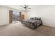 Spacious main bedroom with carpet, ceiling fan, and sliding glass doors to a balcony at 9268 Wildfire Gorge St, Las Vegas, NV 89139
