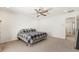 Bright and airy main bedroom with ceiling fan, plush carpet, and ample space at 9268 Wildfire Gorge St, Las Vegas, NV 89139