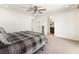 Large main bedroom with ceiling fan and ensuite bathroom entrance; neutral tones throughout at 9268 Wildfire Gorge St, Las Vegas, NV 89139