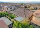 The backyard showcases green lawns, mature trees, and outdoor living spaces, including covered patios and an awning at 9359 Brownstone Ledge Ave, Las Vegas, NV 89149