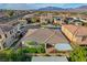 Aerial view shows the house and well-landscaped yard, complete with lawns, mature trees and patio with awning at 9359 Brownstone Ledge Ave, Las Vegas, NV 89149