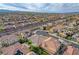 An aerial view showcasing a suburban neighborhood with a mix of two-story homes with desert landscaping and scenic mountain views at 9359 Brownstone Ledge Ave, Las Vegas, NV 89149