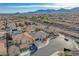 A birds-eye view of the house shows the property's surrounding neighborhood, tile roof, garage and desert landscaping at 9359 Brownstone Ledge Ave, Las Vegas, NV 89149