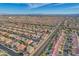 Wide aerial view of a well-planned community with terracotta-roofed homes, tree-lined streets, and views of the Las Vegas skyline at 9359 Brownstone Ledge Ave, Las Vegas, NV 89149