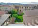 A manicured backyard shows a green lawn, shade trees, and patio areas for outdoor relaxation and entertaining at 9359 Brownstone Ledge Ave, Las Vegas, NV 89149
