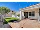 A backyard featuring a patio, artificial grass, and string lights at 9359 Brownstone Ledge Ave, Las Vegas, NV 89149