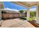 Covered patio showcasing brick wall, string lights, and well-manicured landscaping at 9359 Brownstone Ledge Ave, Las Vegas, NV 89149