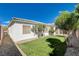 Backyard with artificial grass, landscaping, and desertscape at 9359 Brownstone Ledge Ave, Las Vegas, NV 89149