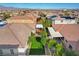 The manicured backyard offers a well-kept lawn, mature trees, a covered patio and additional covered awning space at 9359 Brownstone Ledge Ave, Las Vegas, NV 89149