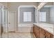 Bright bathroom with dual vanity, large soaking tub, step-in shower and tile floors at 9359 Brownstone Ledge Ave, Las Vegas, NV 89149