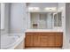 Bright bathroom features double sink vanity, soaking tub, and lots of natural light at 9359 Brownstone Ledge Ave, Las Vegas, NV 89149