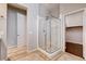 Bathroom featuring tiled floors, glass shower, and walk-in closet at 9359 Brownstone Ledge Ave, Las Vegas, NV 89149
