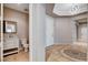 Powder room with modern white vanity and framed mirror, leading into an entryway at 9359 Brownstone Ledge Ave, Las Vegas, NV 89149