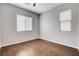 Bedroom featuring wood-look floors, neutral walls, and double-hung windows at 9359 Brownstone Ledge Ave, Las Vegas, NV 89149