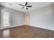 Bedroom with a ceiling fan, wood floors, and access to an outdoor patio via a glass door at 9359 Brownstone Ledge Ave, Las Vegas, NV 89149
