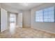 Neutral bedroom features tile flooring, natural light from the large window and a modern ceiling light at 9359 Brownstone Ledge Ave, Las Vegas, NV 89149