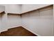 Walk-in closet features hardwood floors and hanging rods at 9359 Brownstone Ledge Ave, Las Vegas, NV 89149