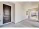Inviting entrance area featuring an arched walkway, a decorative front door, and a glimpse of desert landscaping at 9359 Brownstone Ledge Ave, Las Vegas, NV 89149