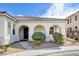 Charming entrance with an arched walkway leading to a decorative front door and desert landscaping at 9359 Brownstone Ledge Ave, Las Vegas, NV 89149