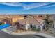 Single-story home featuring a well-manicured front yard, tile roof, arched entryway, and two-car garage at 9359 Brownstone Ledge Ave, Las Vegas, NV 89149