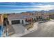 Charming single-story residence with an attached two-car garage, tile roof, landscaped front yard, and inviting arched entryway at 9359 Brownstone Ledge Ave, Las Vegas, NV 89149