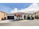 Beautiful home featuring a tiled roof, arched entry, desert landscaping, and a spacious two-car garage in a desirable neighborhood at 9359 Brownstone Ledge Ave, Las Vegas, NV 89149