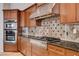 Modern kitchen with stainless steel range, hood and backsplash at 9359 Brownstone Ledge Ave, Las Vegas, NV 89149
