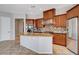 Open-concept kitchen featuring stainless steel appliances and a large island at 9359 Brownstone Ledge Ave, Las Vegas, NV 89149