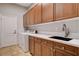 Laundry room with utility sink, plenty of cabinetry, washer, and dryer at 9359 Brownstone Ledge Ave, Las Vegas, NV 89149