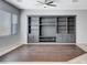 Living room with modern ceiling fan, built-in shelves, and neutral paint at 9359 Brownstone Ledge Ave, Las Vegas, NV 89149