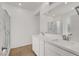 Modern bathroom with dual sinks, sleek countertops, and a large mirror with vanity lighting at 965 Nevada State Dr # 6101, Henderson, NV 89002