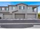 Modern townhome featuring a three car garage with a neutral color scheme and a well-maintained facade at 965 Nevada State Dr # 6101, Henderson, NV 89002