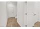Well-lit hallway with wood-look floors and white doors, showcasing modern design at 965 Nevada State Dr # 6101, Henderson, NV 89002