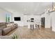 Open-concept living space with a large sectional and view into the white kitchen at 965 Nevada State Dr # 6101, Henderson, NV 89002