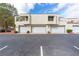 Exterior shot of a home with multiple garage doors and a parking lot with visible parking space lines at , Las Vegas, NV 89117