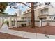 Inviting townhome featuring a charming exterior, tree, and well-kept landscaping at , Las Vegas, NV 89117