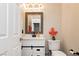 Charming half bath with a decorative mirror and flower accent at 10091 Sand Key St, Las Vegas, NV 89178