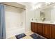 Bathroom featuring a shower-tub combo and a double sink vanity at 10091 Sand Key St, Las Vegas, NV 89178