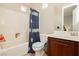 Bathroom features a bathtub/shower combination with dark wood vanity and sink at 10091 Sand Key St, Las Vegas, NV 89178