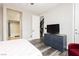 Bright bedroom featuring wood-look floors and access to the bathroom and stairwell at 10091 Sand Key St, Las Vegas, NV 89178