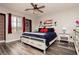 Bedroom with wood-look floors and red decor accents at 10091 Sand Key St, Las Vegas, NV 89178