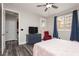 Bedroom featuring wood-look floors, a dresser, and comfortable seating at 10091 Sand Key St, Las Vegas, NV 89178