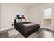 Cozy bedroom with a modern bed frame and a door leading to an outdoor space at 10091 Sand Key St, Las Vegas, NV 89178