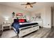 Bedroom with wood-look floors, white furniture and red accents at 10091 Sand Key St, Las Vegas, NV 89178