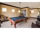 Game room with pool table, chairs, and elegant lighting at 10091 Sand Key St, Las Vegas, NV 89178