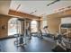 Community gym with cardio and weight machines and large windows overlooking pool area at 10091 Sand Key St, Las Vegas, NV 89178