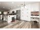 Bright kitchen features stainless appliances, white cabinets, and wood-look flooring at 10091 Sand Key St, Las Vegas, NV 89178