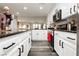 Bright kitchen featuring white cabinetry and granite countertops at 10091 Sand Key St, Las Vegas, NV 89178