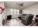 Spacious living room featuring modern furniture, large windows, and a ceiling fan for comfortable living at 10091 Sand Key St, Las Vegas, NV 89178