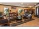 Resident lounge with bar style table, sofas, kitchenette and tile flooring at 10091 Sand Key St, Las Vegas, NV 89178